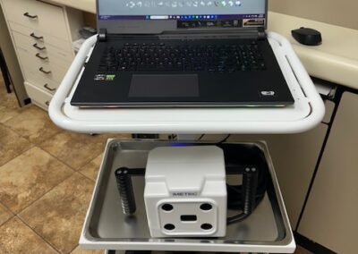 A laptop computer placed on a cart, showcasing a portable workspace setup.